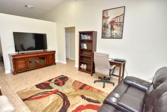 tiled home office featuring visible vents, lofted ceiling, and baseboards