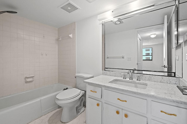 full bathroom featuring tile patterned flooring, vanity, toilet, and tiled shower / bath combo