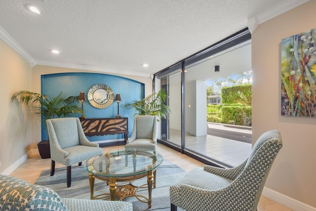 living area with expansive windows, ornamental molding, a textured ceiling, and light hardwood / wood-style flooring