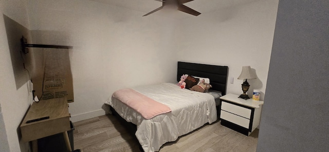 bedroom with ceiling fan and light wood-type flooring