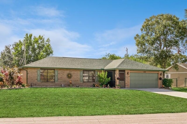 ranch-style home featuring a front yard and a garage