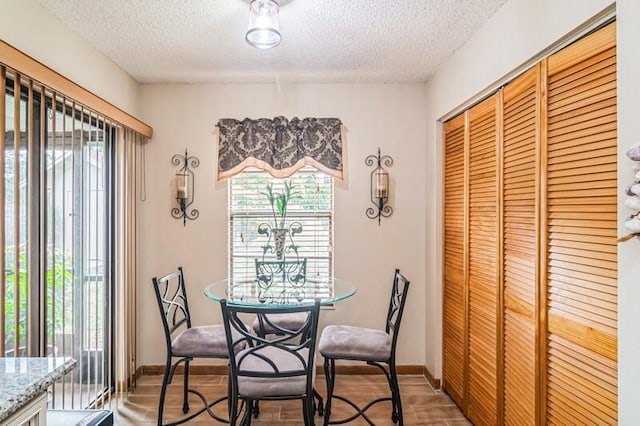 dining area featuring a textured ceiling and hardwood / wood-style flooring