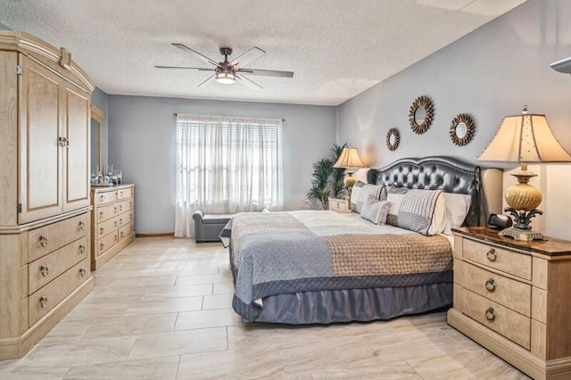 bedroom featuring ceiling fan and a textured ceiling