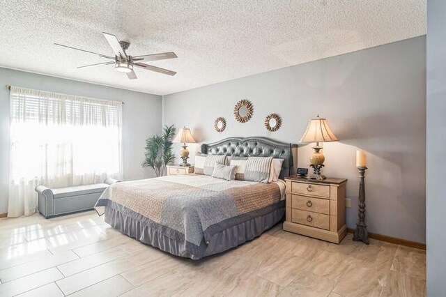 bedroom with ceiling fan and a textured ceiling