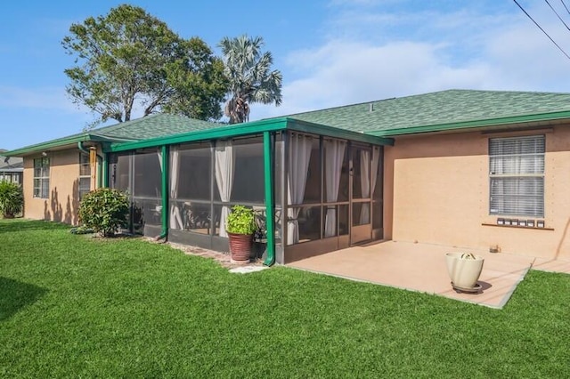 back of property featuring a yard, a patio, and a sunroom