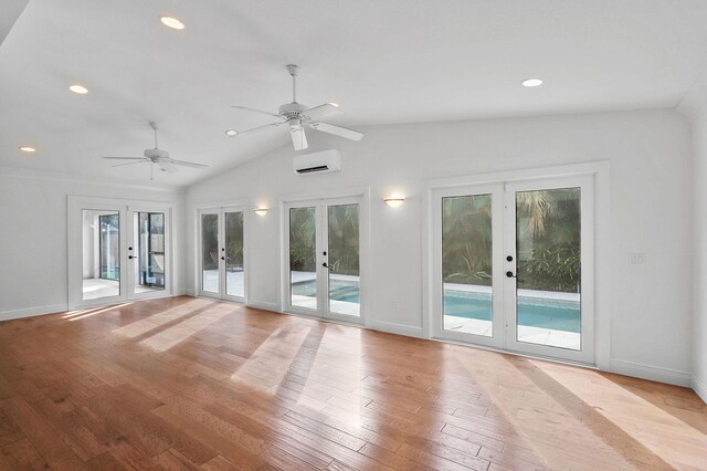 kitchen featuring double oven, wood-type flooring, pendant lighting, white cabinets, and a center island