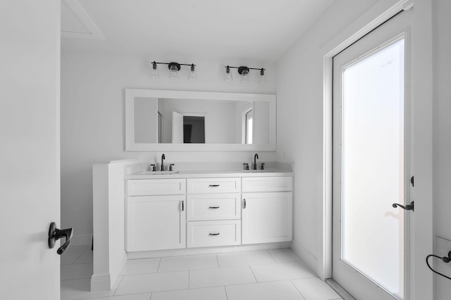 bathroom with double vanity, a healthy amount of sunlight, and a sink