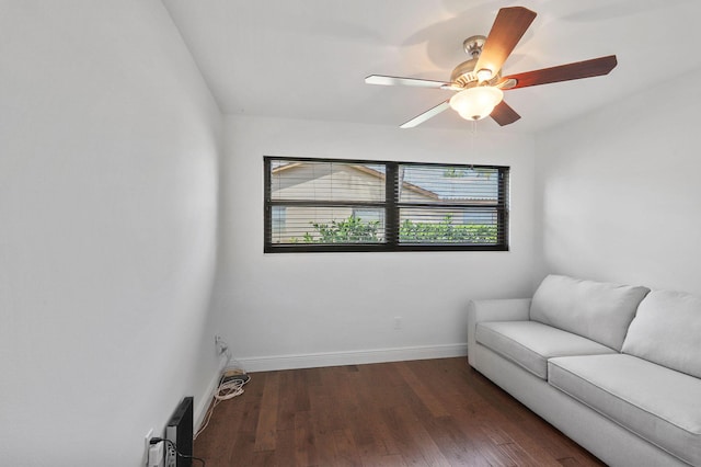 sitting room with a ceiling fan, wood finished floors, and baseboards