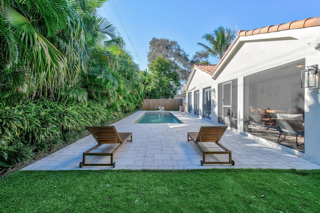 view of pool featuring a patio area and a lawn