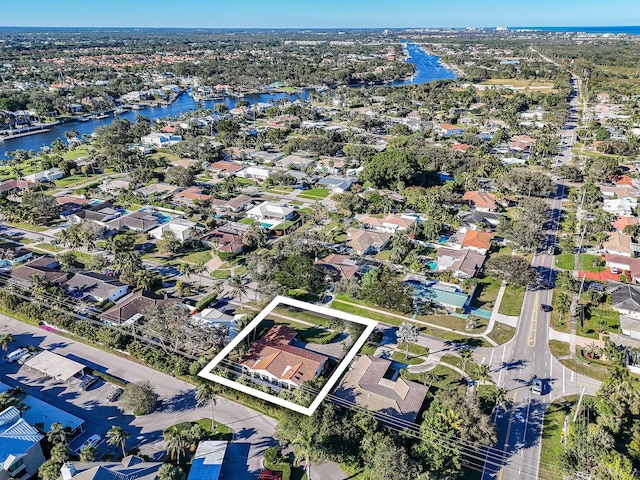 drone / aerial view with a residential view and a water view