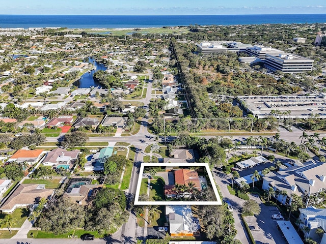 drone / aerial view featuring a water view and a residential view