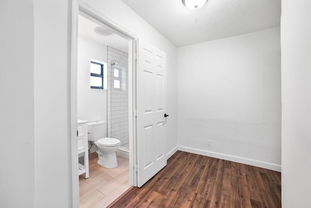 611 Monceaux Rd, West Palm Beach, FL 33405 - full bathroom featuring toilet, a shower stall, and wood finished floors
