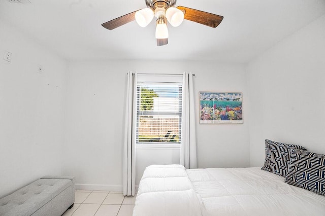 bedroom with ceiling fan and light tile patterned floors