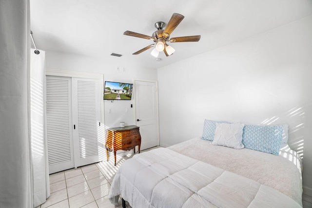 bedroom featuring light tile patterned floors and ceiling fan