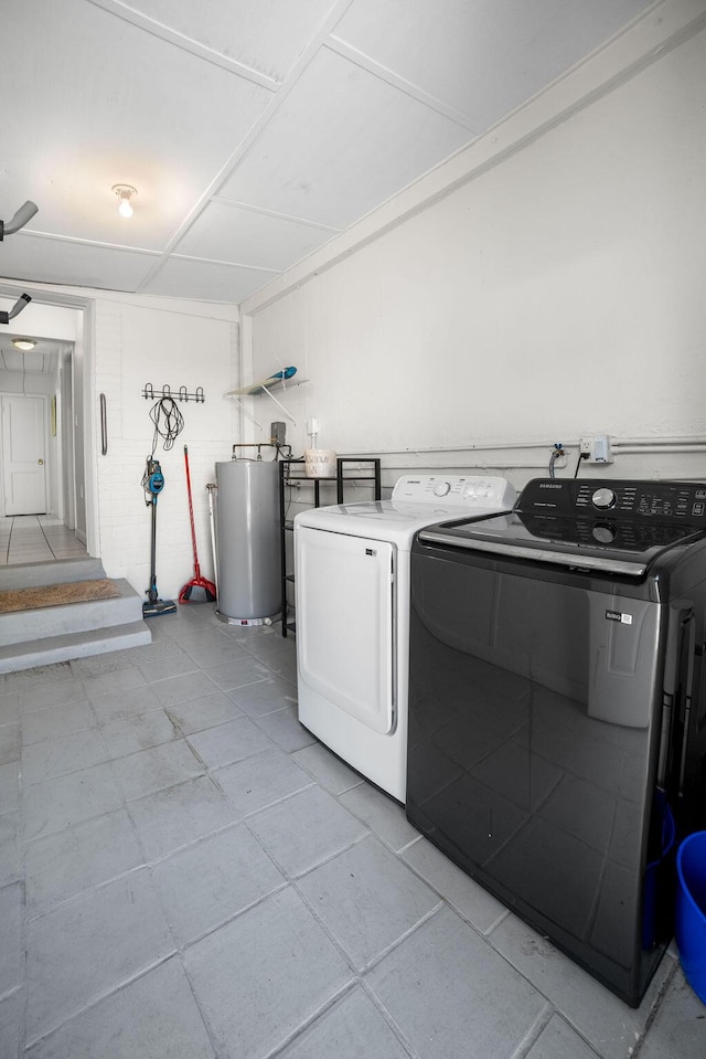 611 Monceaux Rd, West Palm Beach, FL 33405 - laundry room with washing machine and clothes dryer, water heater, and light tile patterned flooring