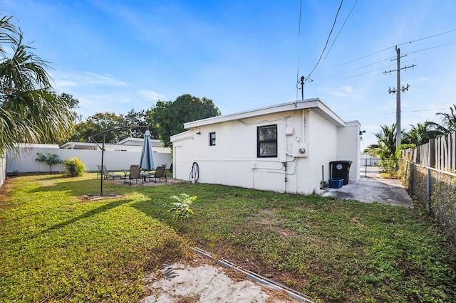 611 Monceaux Rd, West Palm Beach, FL 33405 - back of house with a patio and stucco siding