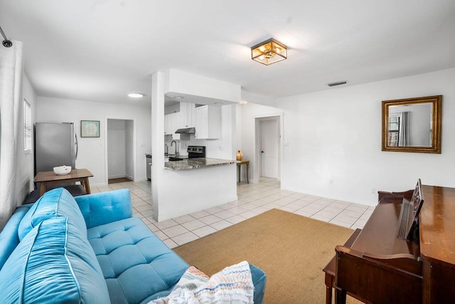 living room with light tile patterned floors and sink