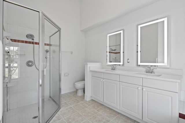 bathroom with vanity, toilet, and a shower with door