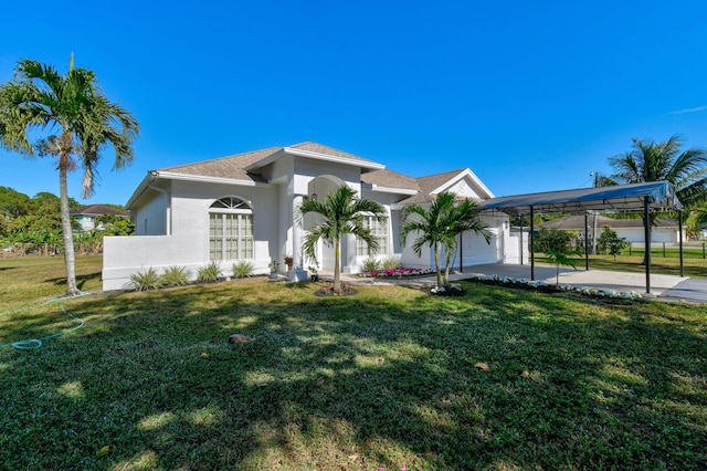 view of front of home featuring a front yard, a garage, and a carport