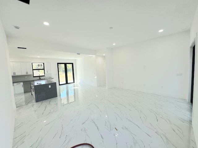 unfurnished living room featuring french doors