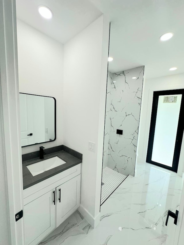 bathroom featuring vanity and tiled shower