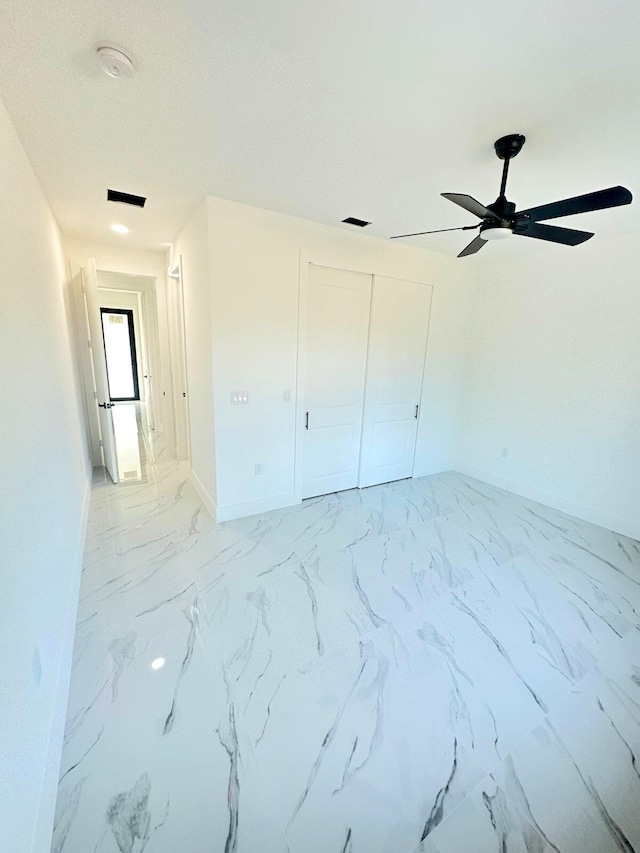 unfurnished bedroom featuring a closet and ceiling fan