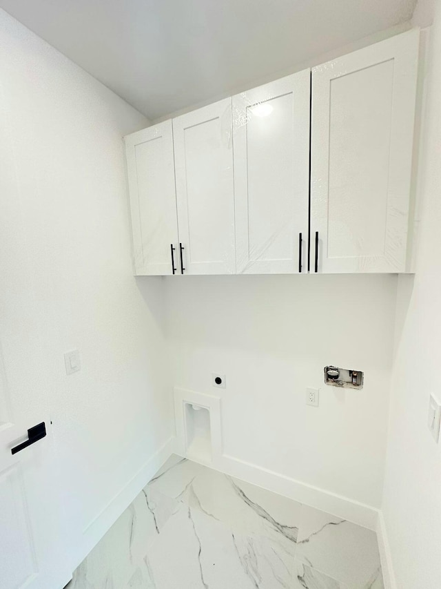 washroom with washer hookup, electric dryer hookup, and cabinets