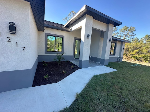 entrance to property with a yard