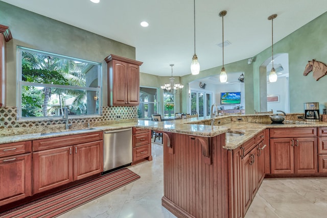 kitchen featuring sink, tasteful backsplash, stainless steel dishwasher, decorative light fixtures, and ceiling fan with notable chandelier