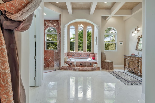 bathroom featuring beam ceiling, a tub, coffered ceiling, a notable chandelier, and vanity