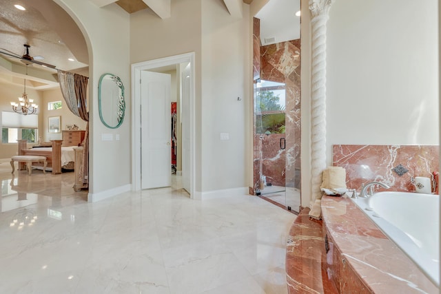 bathroom with ceiling fan with notable chandelier and separate shower and tub