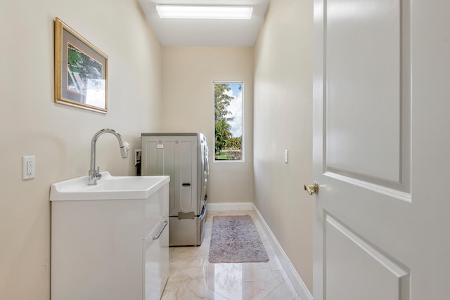 laundry room with washing machine and dryer and sink