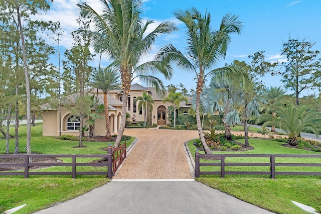 mediterranean / spanish home with a front yard