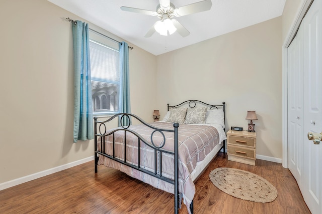 bedroom featuring dark hardwood / wood-style flooring, a closet, and ceiling fan