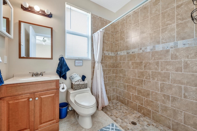 bathroom with tile patterned floors, a shower with curtain, vanity, and toilet