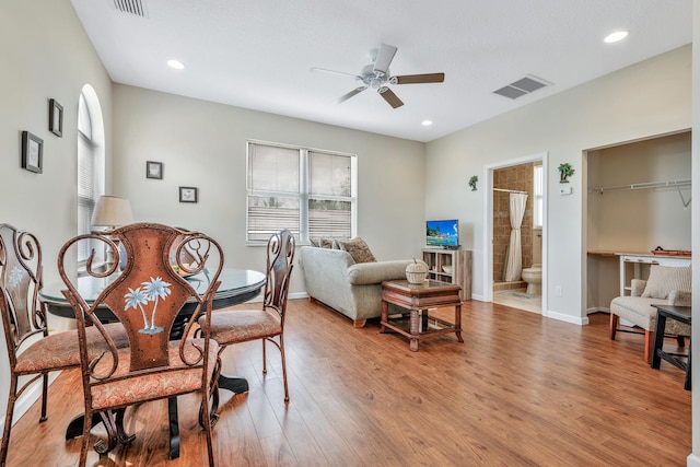 living room featuring ceiling fan and wood-type flooring