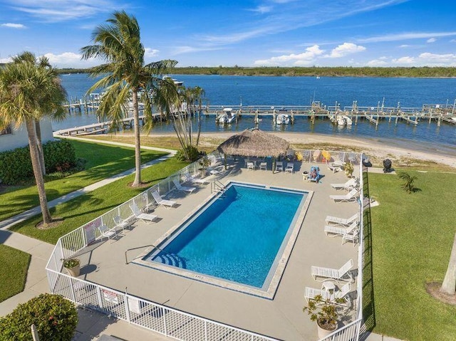 view of pool with a patio area and a water view