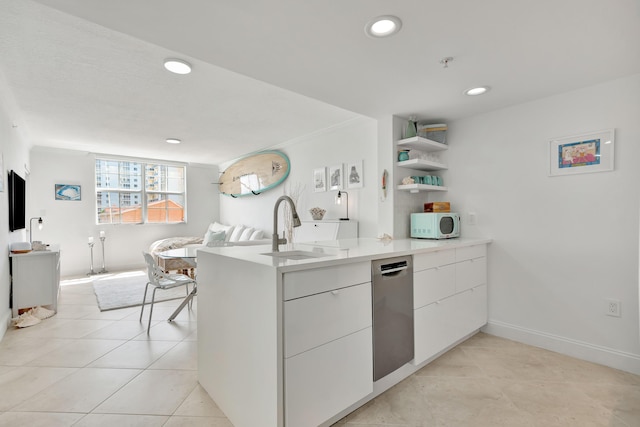 kitchen featuring kitchen peninsula, white cabinetry, dishwasher, and sink