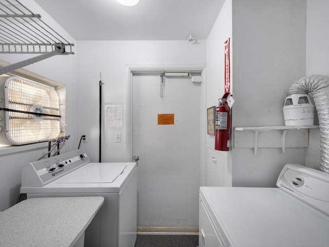 washroom with washing machine and clothes dryer