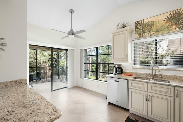 kitchen with dishwasher, sink, light stone counters, cream cabinets, and lofted ceiling