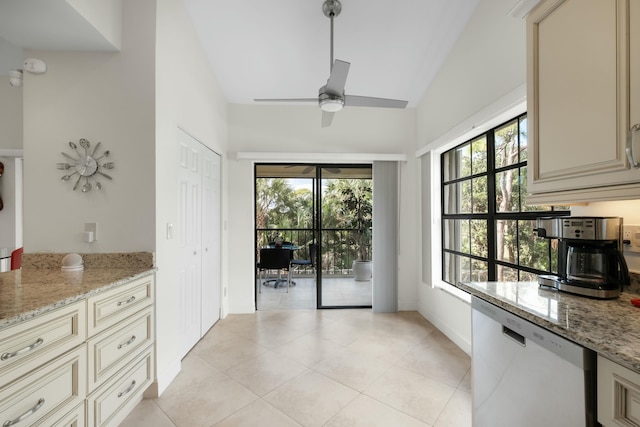 kitchen featuring plenty of natural light, vaulted ceiling, and cream cabinets