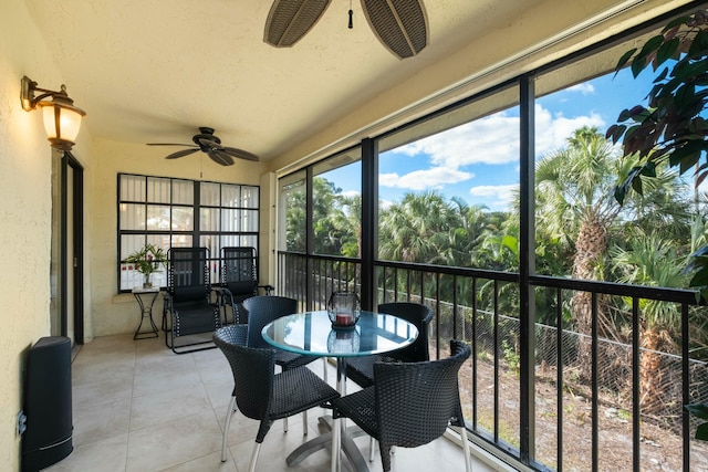 sunroom / solarium featuring ceiling fan