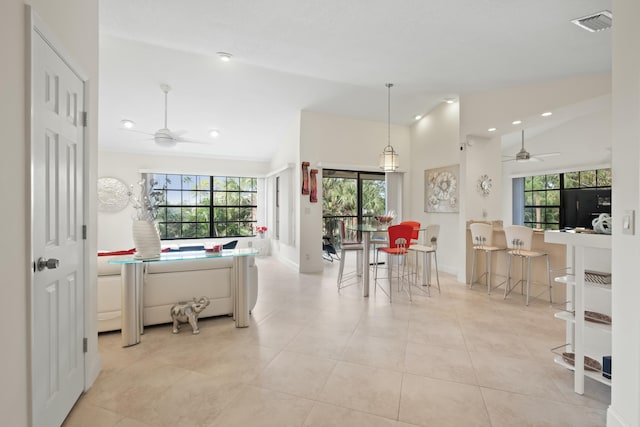 kitchen with vaulted ceiling, plenty of natural light, and ceiling fan