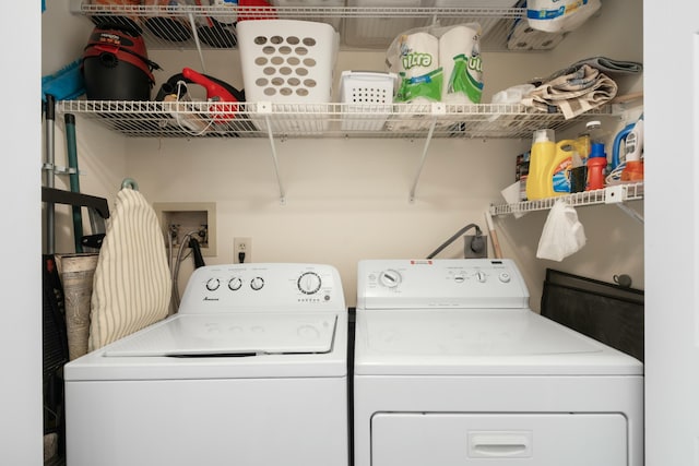 clothes washing area with washing machine and clothes dryer