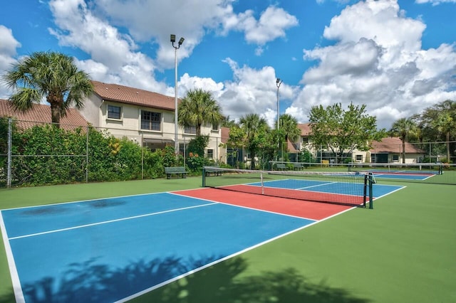 view of tennis court featuring basketball hoop