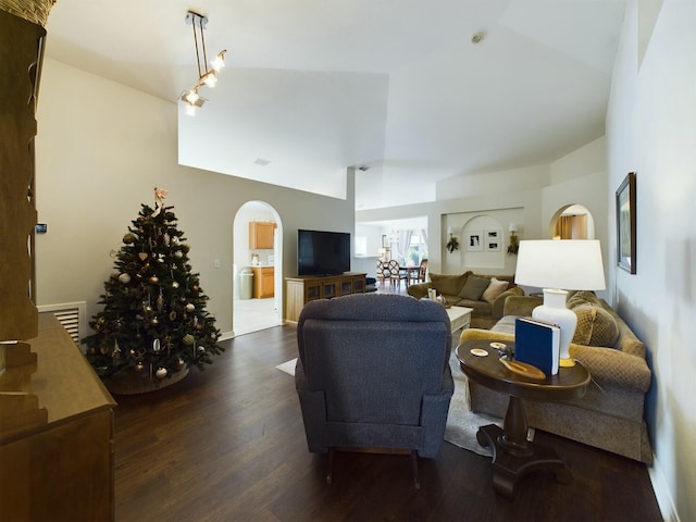 living room featuring dark hardwood / wood-style floors and vaulted ceiling