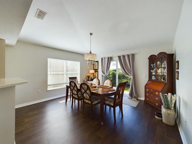 dining room featuring a chandelier and dark hardwood / wood-style flooring