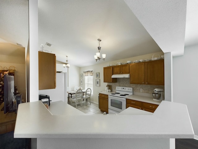 kitchen with backsplash, white appliances, decorative light fixtures, a notable chandelier, and lofted ceiling