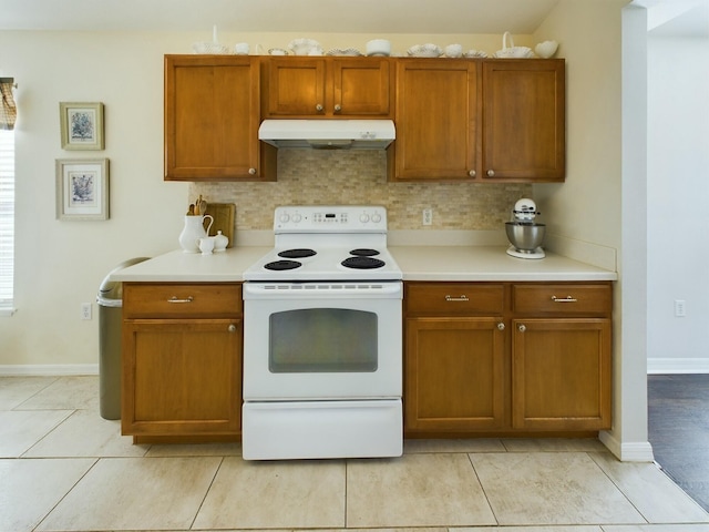 kitchen with white electric range oven, light tile patterned floors, and tasteful backsplash