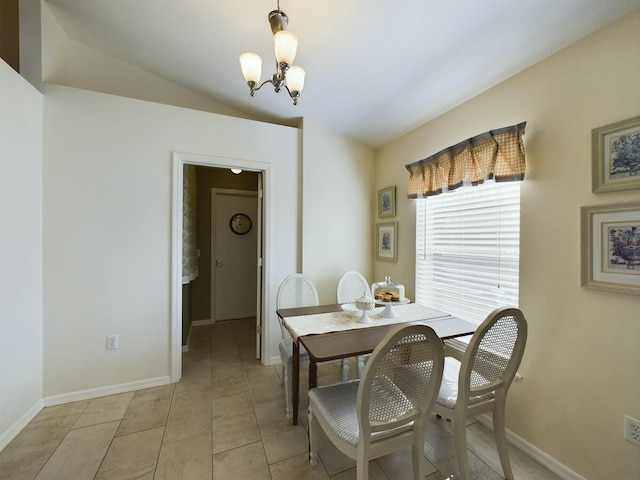 tiled dining area with an inviting chandelier and vaulted ceiling